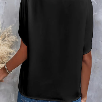 
A woman wearing a black V-neck blouse with split sleeves, suitable for summer work attire. The blouse is paired with jeans, highlighting the elegant and casual style.