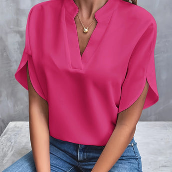 
A woman wearing a pink XXL V-neck split sleeve blouse, styled elegantly for summer work attire.