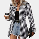 Women's black and white houndstooth blazer with tartan pattern, featuring long sleeves and a tailored fit, styled with a dress shirt underneath, suitable for office wear.