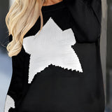 Women's black and white crewneck sweater featuring a star pattern, showcasing long sleeves and a cozy knit texture, perfect for stylish outerwear.