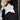 Women's black and white crewneck sweater featuring a star pattern, showcasing long sleeves and a cozy knit texture, perfect for stylish outerwear.