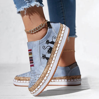 Women's blue denim sneakers with cat embroidery, casual slip-on style.