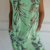 Women's green floral knee-length dress, featuring a lightweight fabric ideal for summer. The dress is styled as a tunic with a comfortable fit, showcasing a one-piece design. The image highlights the shoulder and arm features, and the green color is prominent throughout the garment.