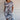 Women's blue floral knee-length dress featuring a lightweight summer tunic design, shown in size 5XL. The dress has short sleeves, a round neckline, and a flattering fit around the waist. The model is smiling, showcasing the dress's comfortable and stylish look.
