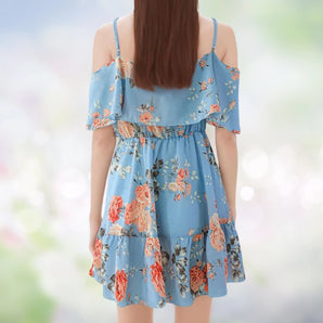 
Women's blue floral off-shoulder summer mini dress with pink and azure floral patterns, featuring short sleeves and a fitted waist.
