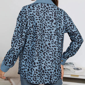 
A women's blue leopard print shirt with long sleeves and a stylish design, paired with jeans. The shirt features a chic animal print pattern, suitable for casual or semi-formal wear.