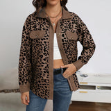 Woman wearing a chic and stylish women's blue leopard print shirt, paired with jeans. The woman is posing outdoors, with sunglasses on her head, showcasing the long sleeves and fashionable design of the blouse.
