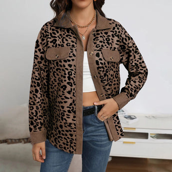 Woman wearing a chic and stylish women's blue leopard print shirt, paired with jeans. The woman is posing outdoors, with sunglasses on her head, showcasing the long sleeves and fashionable design of the blouse.