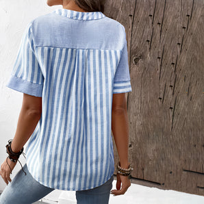 Women's blue striped cotton blouse with half sleeves, shown on a model with visible shoulders and arms.