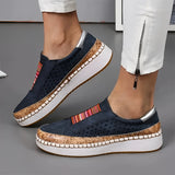 Women's black slip-on sneakers made from suede material, featuring a perforated design for breathability, suitable for comfortable walking.