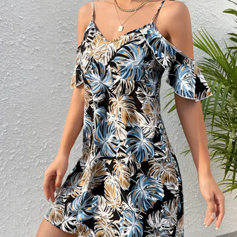 Women's blue and white floral cold-shoulder summer dress showcasing a stylish one-piece garment with exposed shoulders, worn by a person with a visible arm and hand, set against a subtle backdrop that highlights the dress's floral pattern.