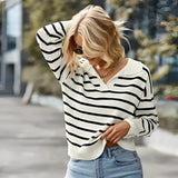
A women's blue and white striped lightweight pullover sweater with long sleeves and a round neckline.