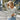 
A women's blue and white striped lightweight pullover sweater with long sleeves and a round neckline.