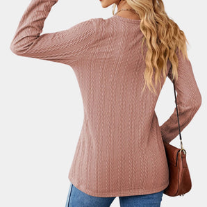 Blush pink cable knit turtleneck sweater featuring a cozy design with detailed cable patterns, long sleeves, and a high collar, perfect for fall fashion.