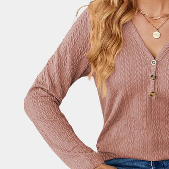 Blush pink cable knit turtleneck sweater for women, featuring a cozy fall fashion design with long sleeves and a textured pattern.