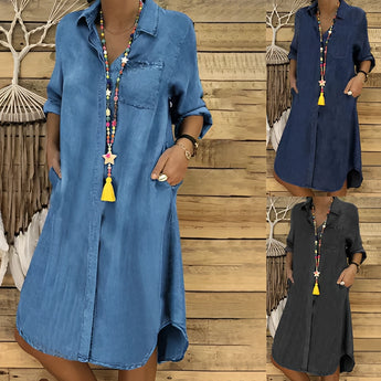 Women's boho denim tunic dress in a vintage wash, featuring long sleeves and a comfortable, relaxed fit. The dress displays a stylish design with a focus on fashion, showcasing a combination of blue and white hues. Suitable for casual or semi-formal wear, the one-piece garment highlights the neck and shoulder areas elegantly.