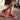 
A pair of women's bright red walking sneakers displayed, showcasing their sporty and comfortable design.