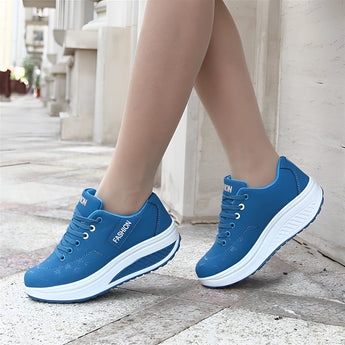 Bright blue women's walking sneakers on a person's feet, showcasing a comfortable and stylish design ideal for everyday wear.