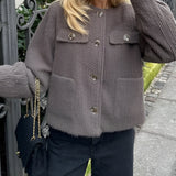 Brown corduroy oversized jacket for women featuring a trendy casual urban style, with plaid detailing on the fabric, long sleeves, and a relaxed fit.