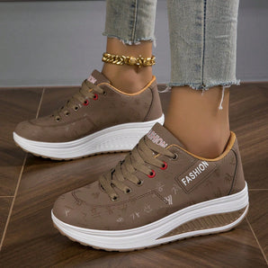 
A pair of women's brown platform sneakers featuring trendy lace-up design and ankle support, displayed against a neutral background.