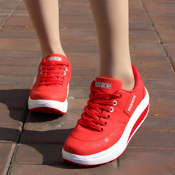 Women's red platform sneakers with trendy lace-up design and ankle support, featuring a textile upper and sporty style.