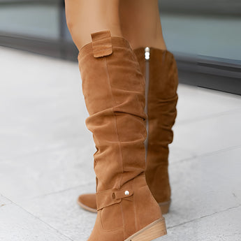 Women's brown suede slouchy knee-high boots in a bohemian fall style, showcasing the soft suede texture and relaxed fit around the leg.
