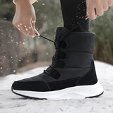Women's brown waterproof insulated high-top snow boots displayed on a model, showcasing their stylish design suitable for snowy conditions.
