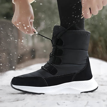 Women's brown waterproof insulated high-top snow boots displayed on a model, showcasing their stylish design suitable for snowy conditions.