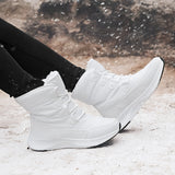 Women's brown high-top snow boots with a stylish design, shown worn with jeans. The boots are waterproof and insulated, suitable for outdoor winter conditions.