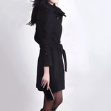 Women's brown wool double-breasted trench coat featuring a stylish design, showcasing elements such as long sleeves, a tailored waist, and a broad collar. The fashion model is displaying the coat's elegant structure with its thigh-length cut and blazer-like details.