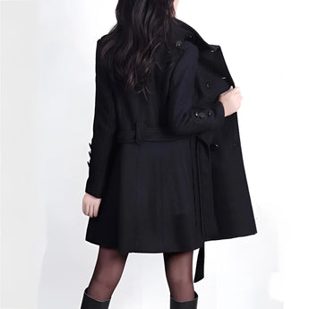 Women's brown wool double-breasted trench coat featuring a stylish and fashionable design. The coat has a prominent collar, long sleeves, and a defined waist, showcasing its elegant winter wear appeal. Made from natural materials, it combines the functionality of a coat with the sophistication of a blazer.