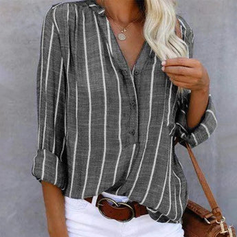 Woman wearing a burgundy striped blouse with a casual button-up design, featuring rolled sleeves.
