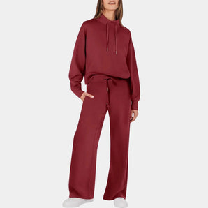 Women's burgundy tracksuit in wine red, featuring a comfy hoodie with a collar and wide-leg sweatpants in size 3XL. The tracksuit showcases a stylish fashion design with long sleeves and a relaxed fit at the waist.