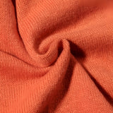 Women's burnt orange V-neck sweater with a soft knit texture and relaxed fit, featuring long sleeves and a simple, elegant design.