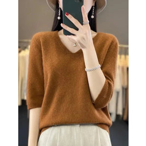 Women's camel cashmere V-neck short sleeve sweater in size 2XL, featuring a soft, luxurious fabric perfect for fall fashion. The sweater is styled with a casual and elegant look, complementing the shoulder and waist areas while showcasing short sleeves.