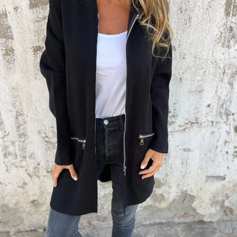 Black women's coat in lightweight wool, featuring a casual chic design with a structured collar and long sleeves, suitable for fall outerwear.
