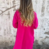 Elegant women's camel coat made from lightweight wool, featuring a casual chic design perfect for fall. The coat has long sleeves and a tailored waist, complementing the overall stylish look.