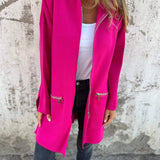 
A woman wearing a pink lightweight wool fall jacket, showcasing a casual chic outerwear style. The coat features a collar, tailored waist, and long sleeves.