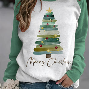Women's festive green sleeve pullover hoodie featuring a large Christmas tree graphic on the front, styled with jeans.
