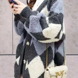 Women's chunky knit houndstooth oversized cardigan sweater in dark gray, showcasing long sleeves, a pronounced collar, and a classic black-and-white houndstooth pattern.