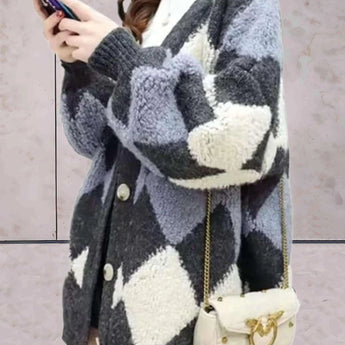 Women's chunky knit houndstooth oversized cardigan sweater in dark gray, showcasing long sleeves, a pronounced collar, and a classic black-and-white houndstooth pattern.