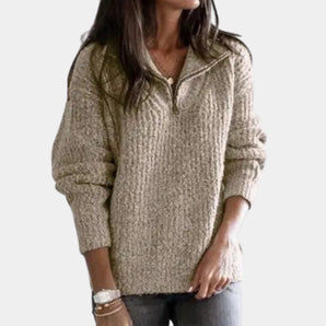 
A women's chunky oatmeal sweater featuring a half-zip design, cozy knit fabric, and long sleeves, shown in a khaki color, size XL.