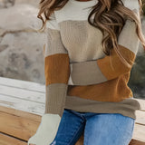 Women's color-blocked cozy knit sweater featuring a trendy tri-color design with sections of white and other complementary shades. The sweater showcases long sleeves and a comfortable fit over the shoulders and neck, creating a stylish look suitable for various body types.