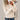 
A women's beige cable knit sweater in size 3XL with a cozy winter fashion design, featuring long sleeves and a comfortable fit around the shoulders and waist.