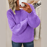 
A woman wearing a cozy purple cable knit sweater in a 3XL size, featuring a textured pattern with long sleeves and a collar.