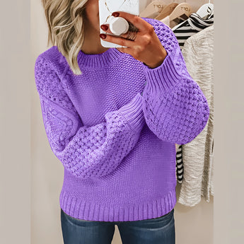 
A woman wearing a cozy purple cable knit sweater in a 3XL size, featuring a textured pattern with long sleeves and a collar.