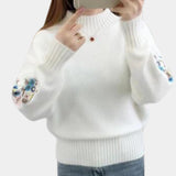 Women's white cozy floral embroidered sweater featuring long sleeves and a round neck, shown in an XL size. Suitable for autumn and winter fashion, the sweater highlights detailed floral embroidery on the fabric.