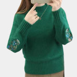 
A green women's cozy floral embroidered sweater in XL size, featuring long sleeves, a round neck, and intricate floral embroidery, ideal for autumn and winter fashion.