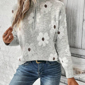 Women's gray floral knitwear pullover with flower applique design, featuring a zipper closure. The model is wearing the 3XL variant, showcasing the long sleeves and comfortable fit.