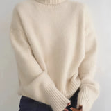 Women's grey oversized cashmere turtleneck sweater with long sleeves, showcasing a cozy and warm design, perfect for outerwear.